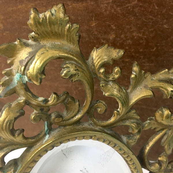Ornate brass finish vanity mirror - oval beveled glass - 1960s - NextStage Vintage