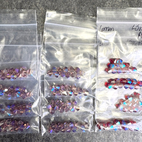 144 pcs 6mm crystal bicone beads - lt topaz 2x/AB and lt siam ABS - Swarovski?