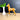 Horse figurine next to a vase with greenery on a wooden surface with a blackboard background
