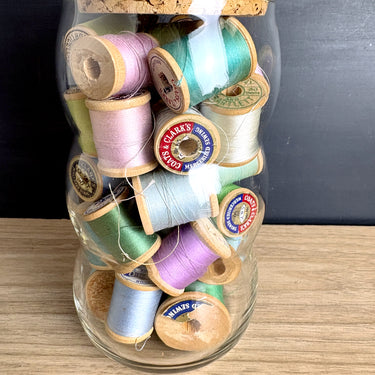Vintage Wooden Thread Spools in Bubble Glass Jar with Cork Lid - Blues Greens Purples - Sewing Room Decor - NextStage Vintage