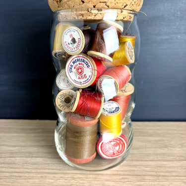 Vintage Wooden Thread Spools in Bubble Glass Jar with Cork Lid - Reds Golds Oranges Browns - Sewing Room Shelf Decor - NextStage Vintage