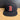 Black baseball cap with a red 'B' logo on a wooden surface.