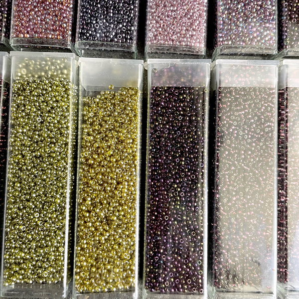 850 grams of 11/0 round seed beads - earth tones - estate destash lot