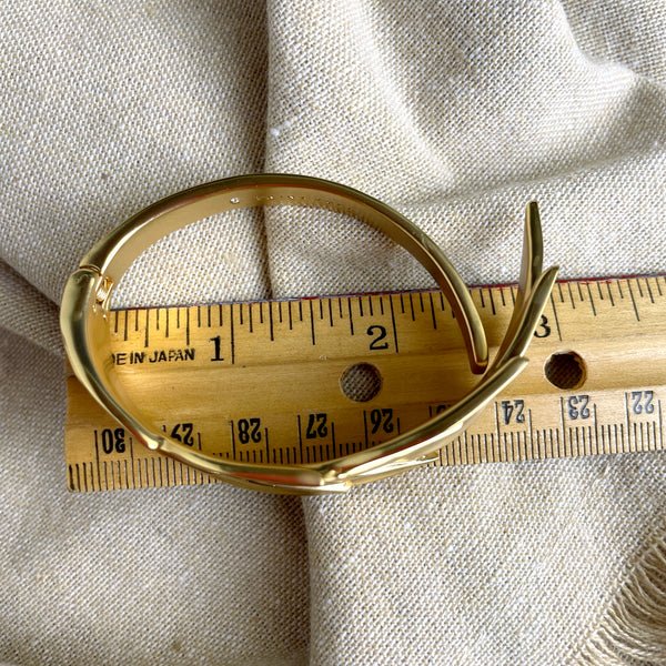 Trina Turk goldtone hinged leaf cuff bracelet