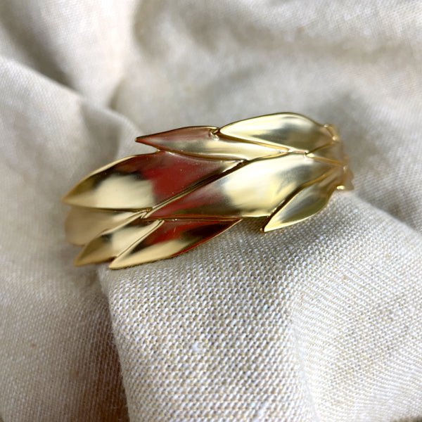 Trina Turk goldtone hinged leaf cuff bracelet